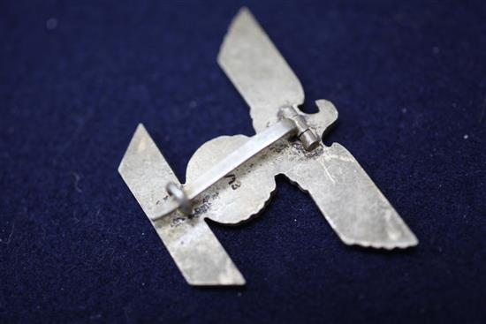A collection of various German Third Reich cap badges, cloth badges and pins
